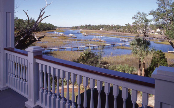 rear balcony of beach/coastal style house design with water nearby