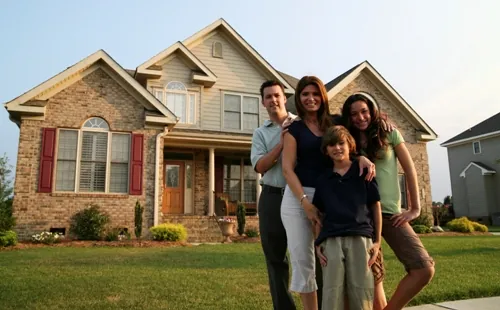 Designer Dream Home family in front of their dream home