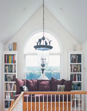 narrow bookcases flanking a large arched window narrow bookcases flanking a large arched window